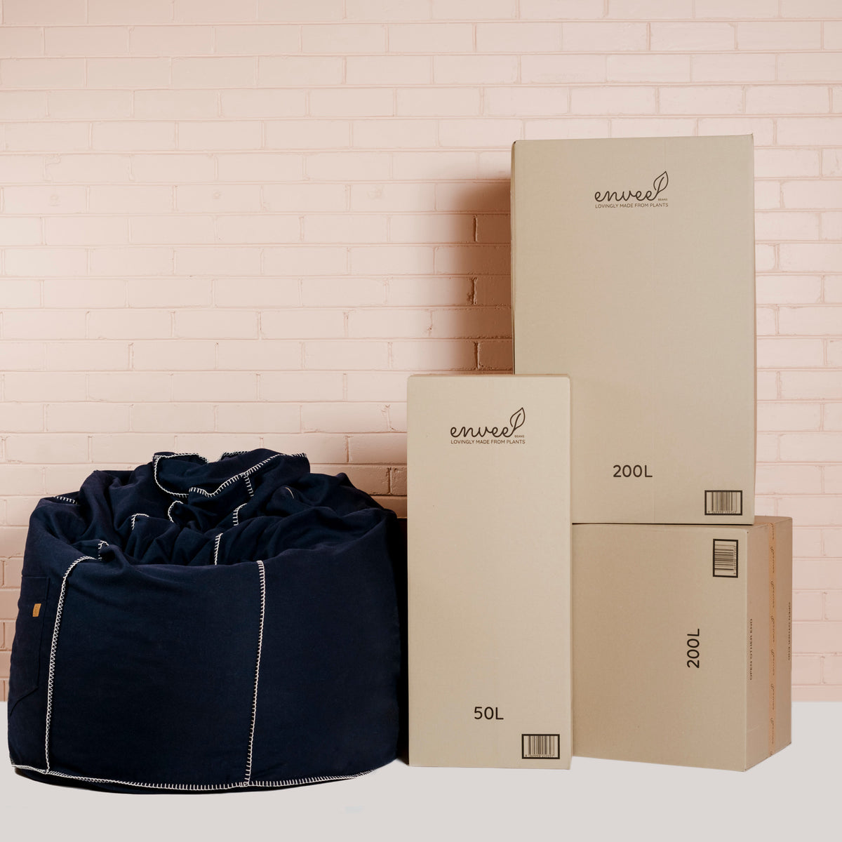 Envee shipping cartons beside a filled navy bean bag