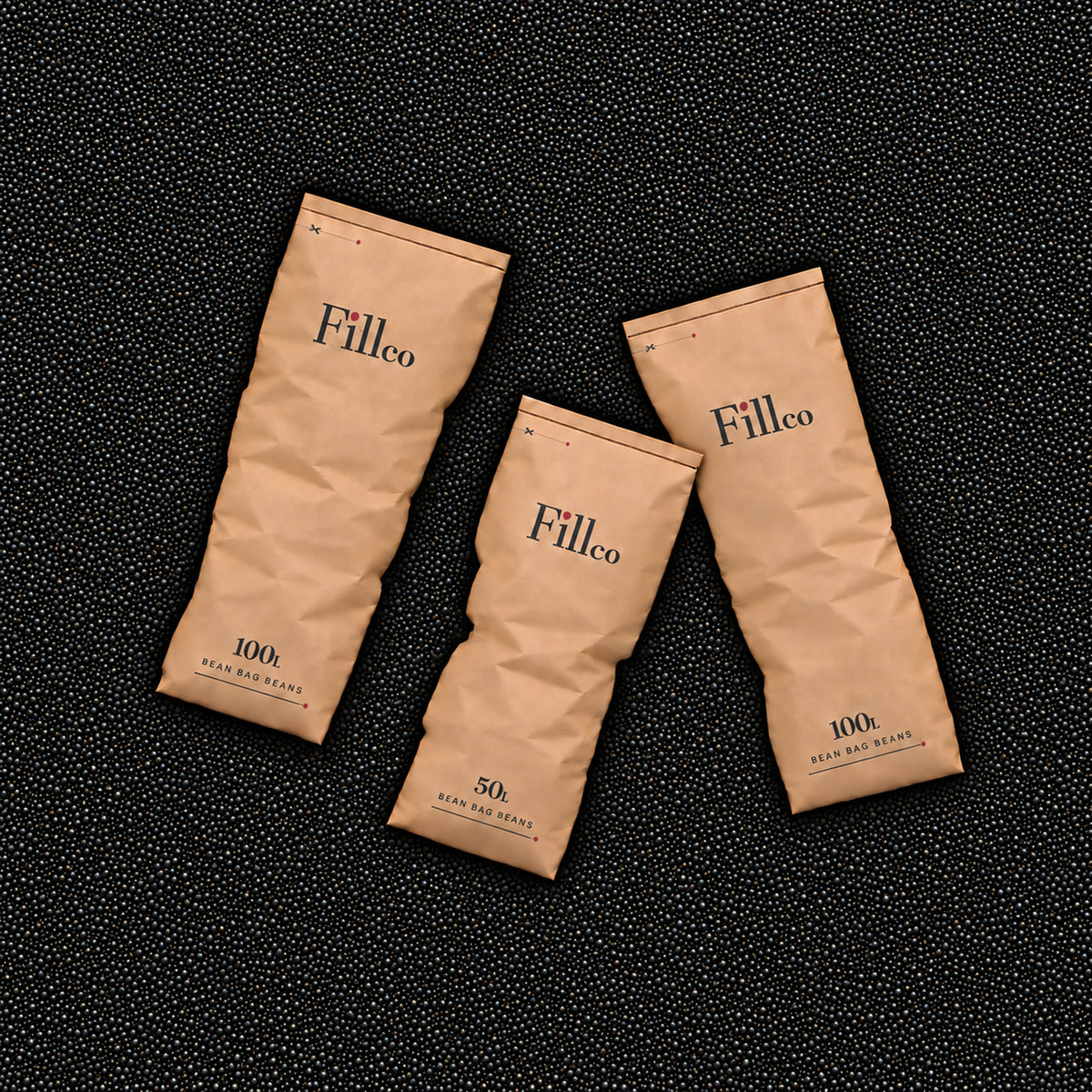 Three Fill Co paper bags lying on a bed of Black beans