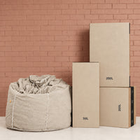 Fill Co shipping cartons, 50 L and 200 L, beside a filled oatmeal bean bag
