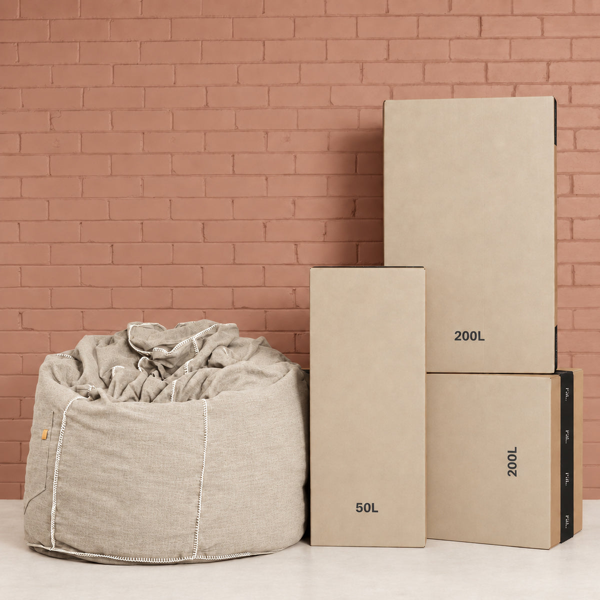 Fill Co shipping cartons, 50 L and 200 L, beside a filled oatmeal bean bag