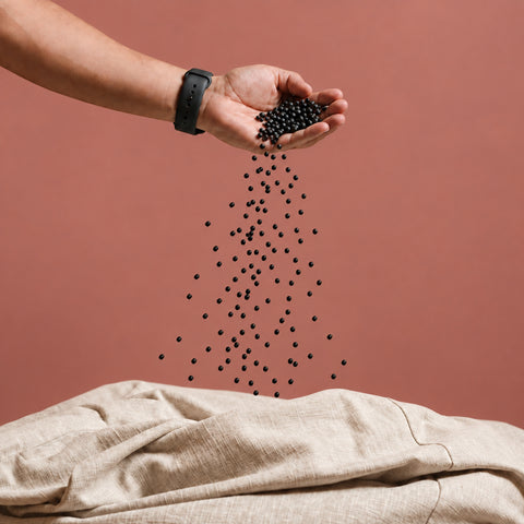 Pouring Fill Co Black beans from one hand into an oatmeal cover