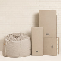 Fill Co shipping cartons, 50 L and 200 L, beside a filled oatmeal bean bag