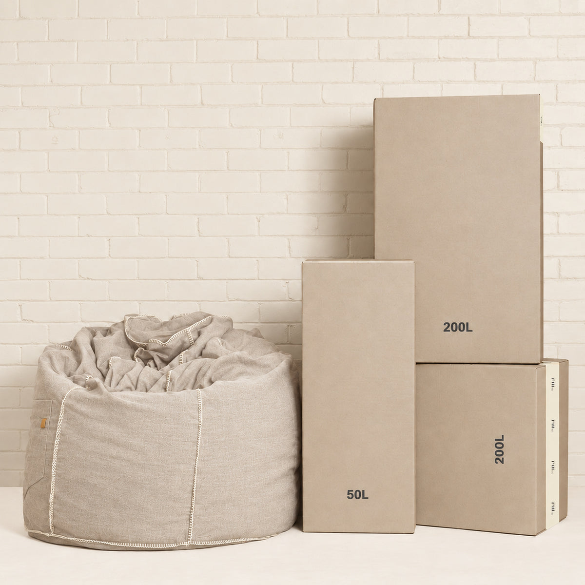 Fill Co shipping cartons, 50 L and 200 L, beside a filled oatmeal bean bag
