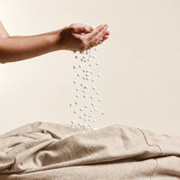 Fill Co White beans poured from cupped hands into an oatmeal cover